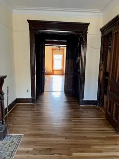 a view of hallway with wooden floor and stairs