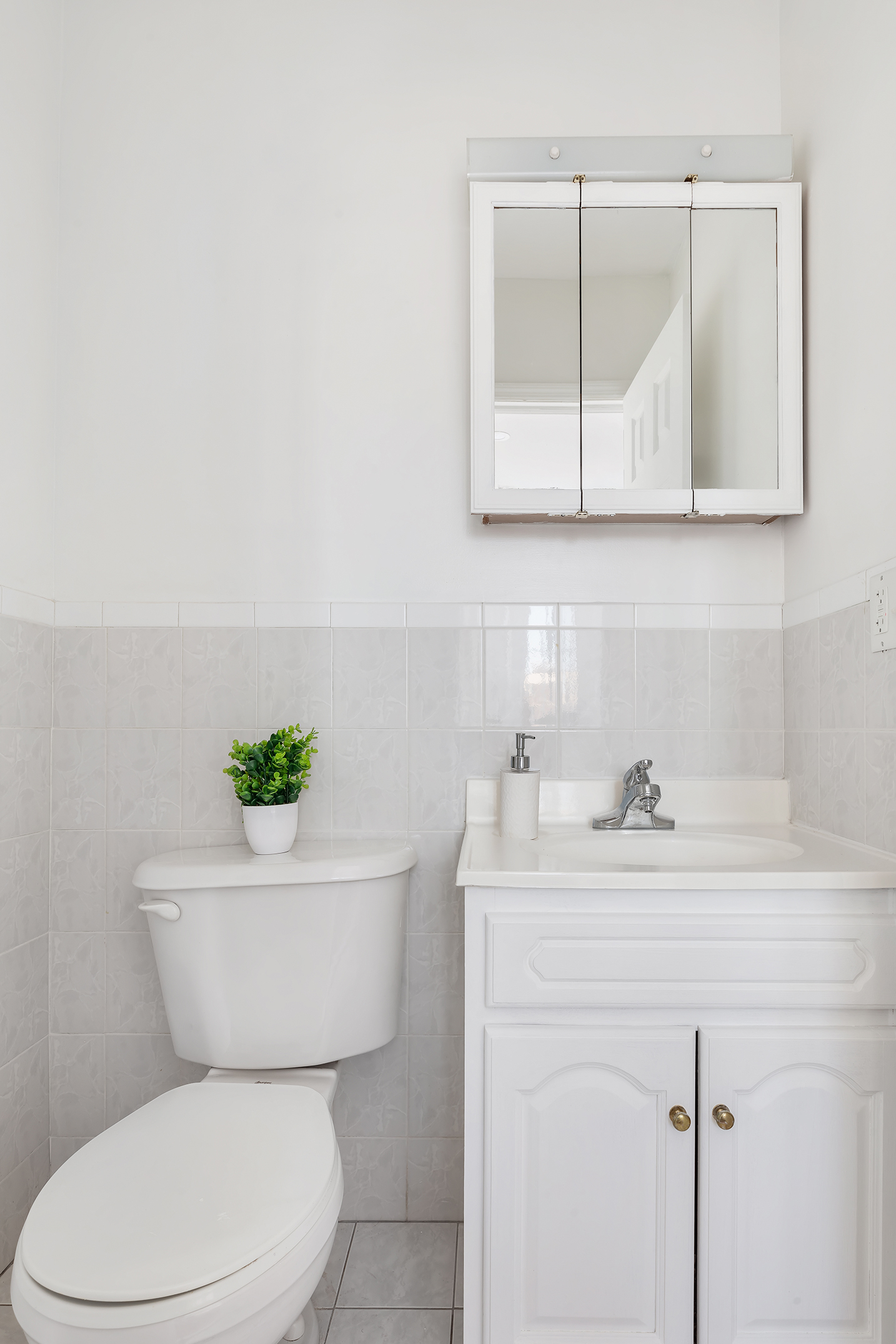 97 Moore Street, Unit 4B Brooklyn, NY 11206 - Photo 7 of 8 a bathroom with a toilet sink and mirror