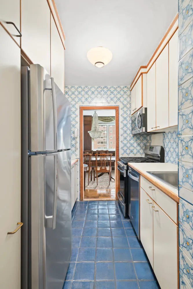 a kitchen with stainless steel appliances granite countertop a refrigerator and a sink