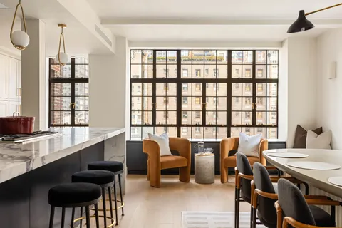 a view of a dining room with furniture and window