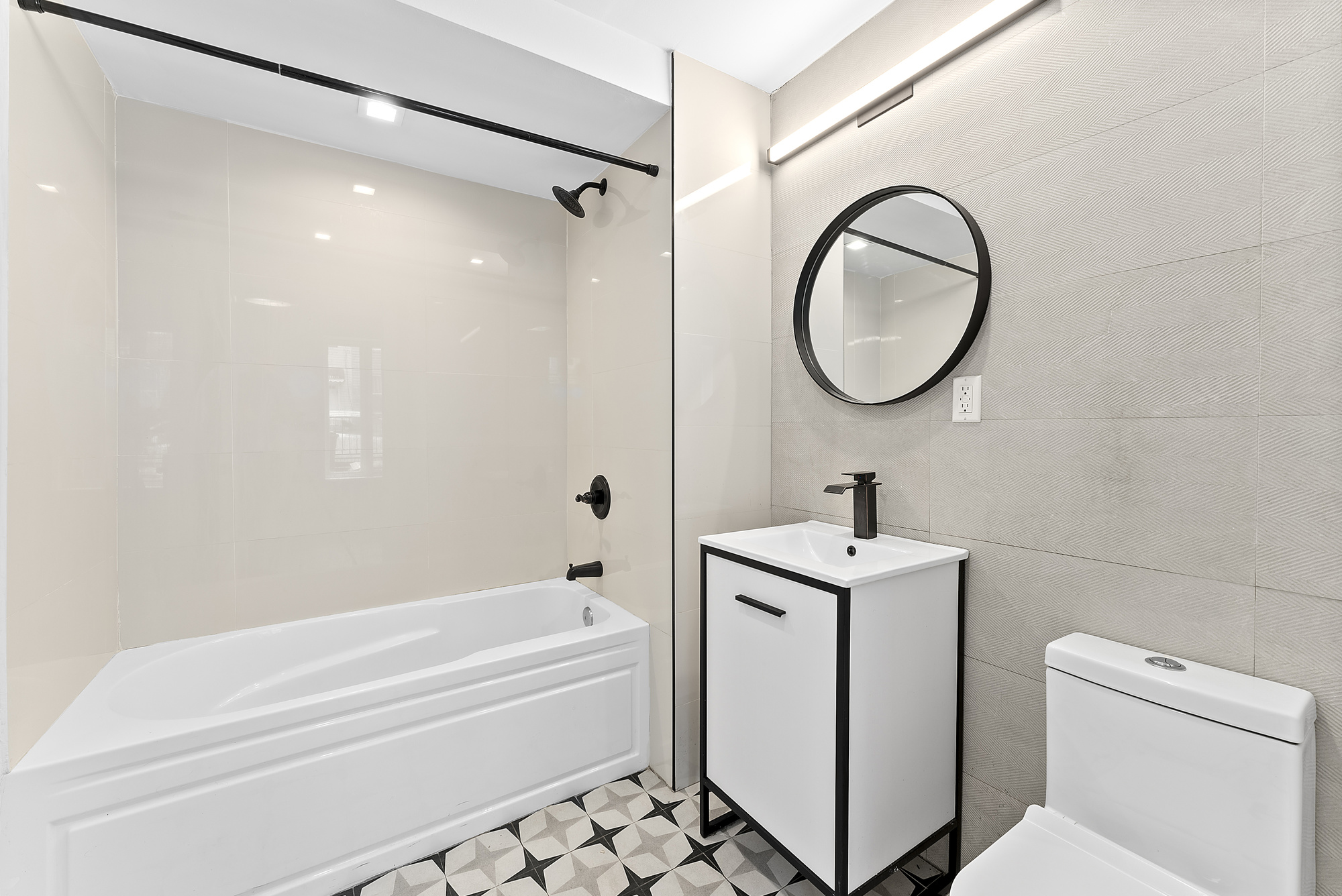 81 Eldert Street, Unit 1 Brooklyn, NY 11207 - Photo 6 of 9 a bathroom with a sink a toilet and a mirror