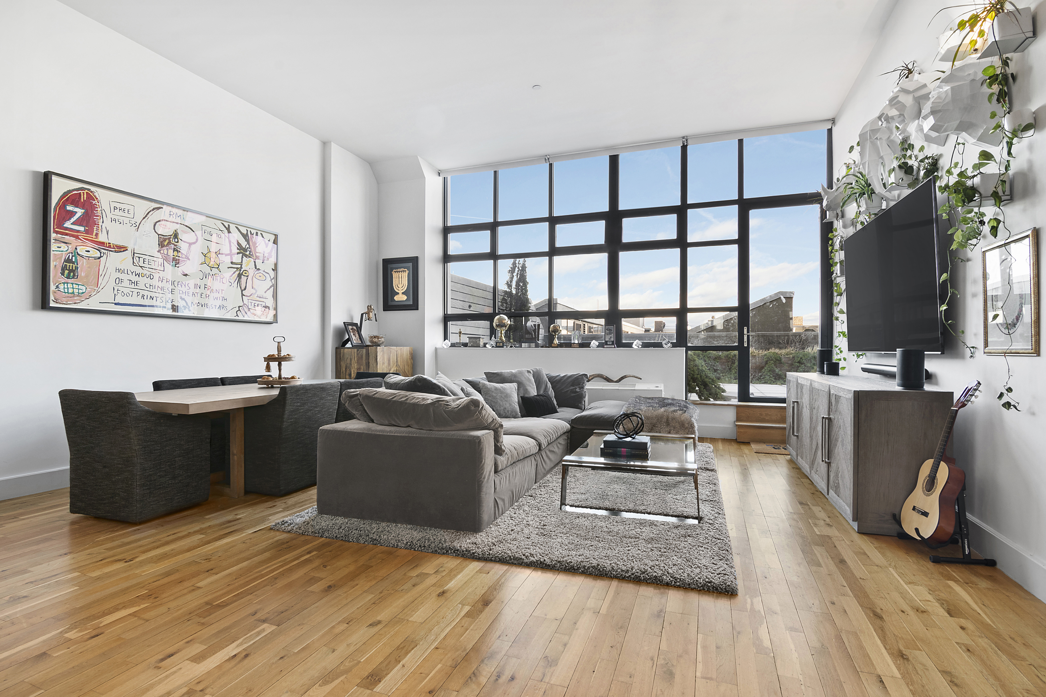 360 Furman Street, Unit 326 Brooklyn, NY 11201 - Photo 2 of 42 a living room with furniture a flat screen tv and a floor to ceiling window