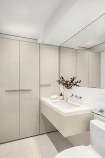 a bathroom with a sink mirror and toilet