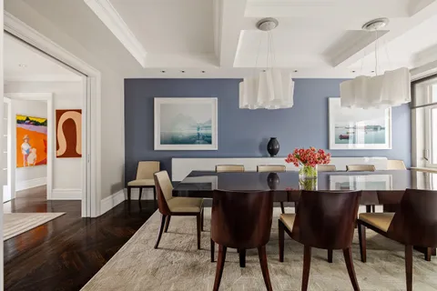 a dining room with wooden floor and breakfast area