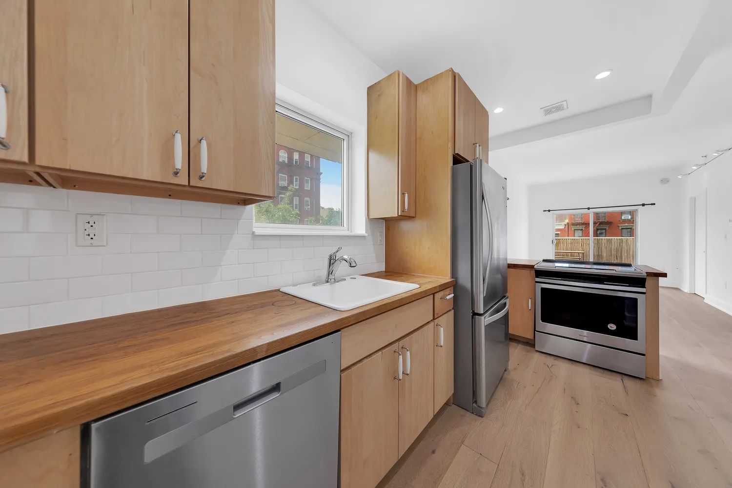 a kitchen with a sink and a stove top oven