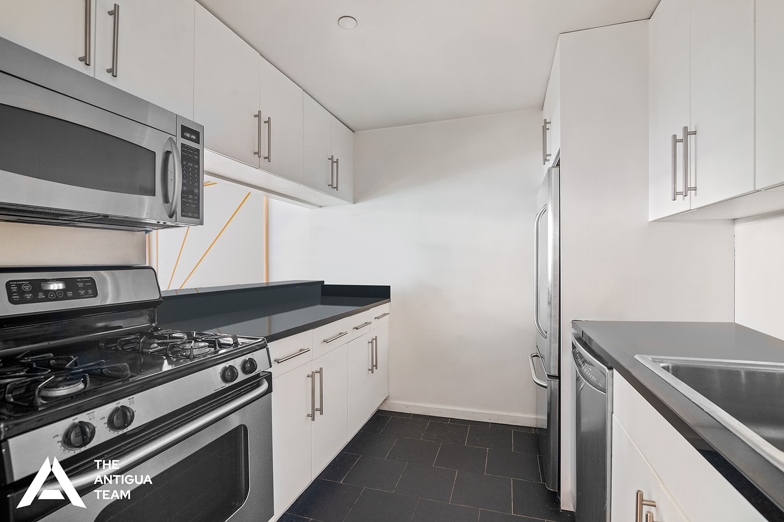 300 West 135th Street, Unit 2M Manhattan, NY 10030 - Photo 4 of 8 a kitchen with a stove and a microwave