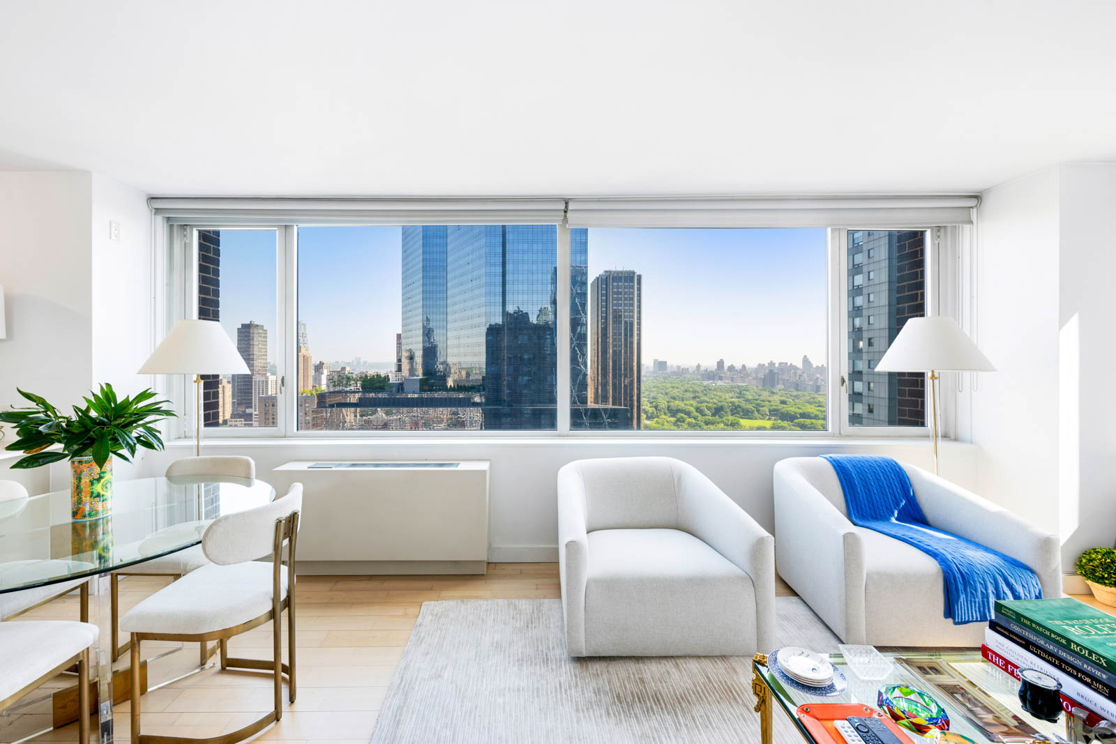 322 West 57th Street, Unit 50H Manhattan, NY 10019 - Photo 2 of 7 a living room with furniture and a large window