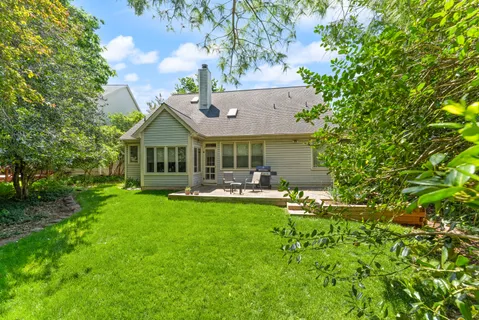 a front view of a house with swimming pool having outdoor seating