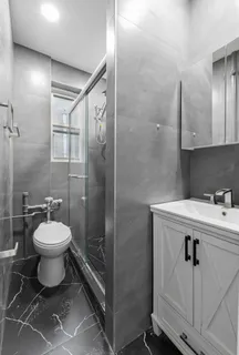 a bathroom with a toilet sink and shower