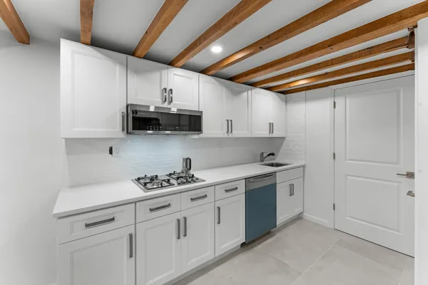 a kitchen with stainless steel appliances white cabinets and a sink