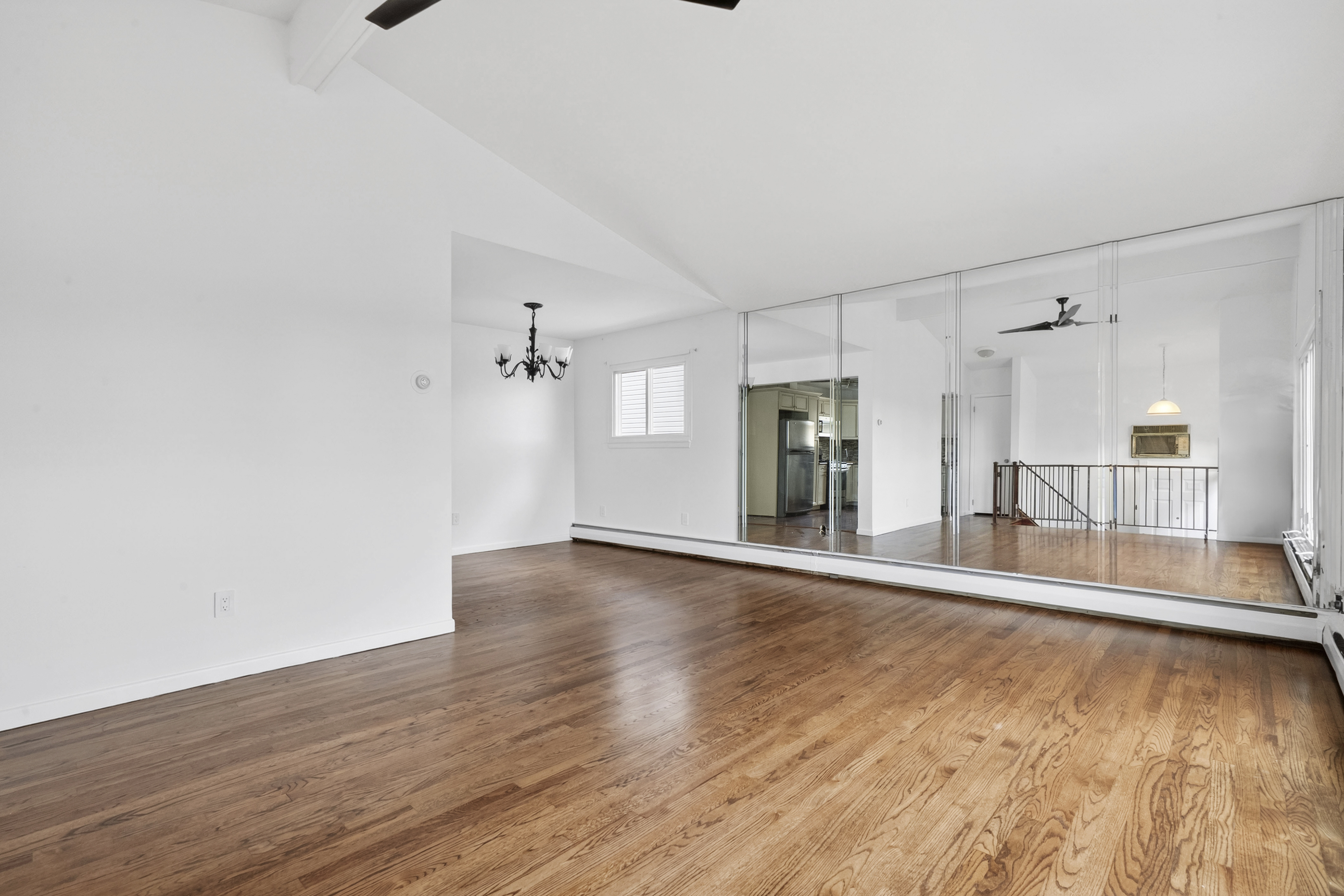 29 Athena Place Staten Island, NY 10314 - Photo 3 of 10 a view of a big room with wooden floor and windows