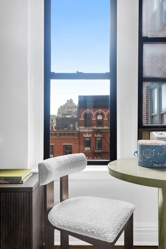 a dining room with furniture and a floor to ceiling window
