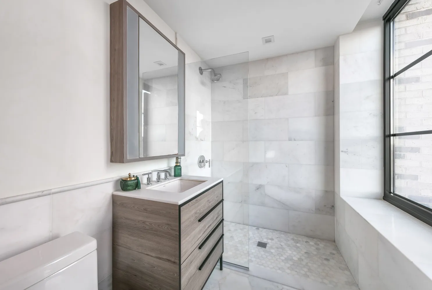 a bathroom with a shower sink and mirror