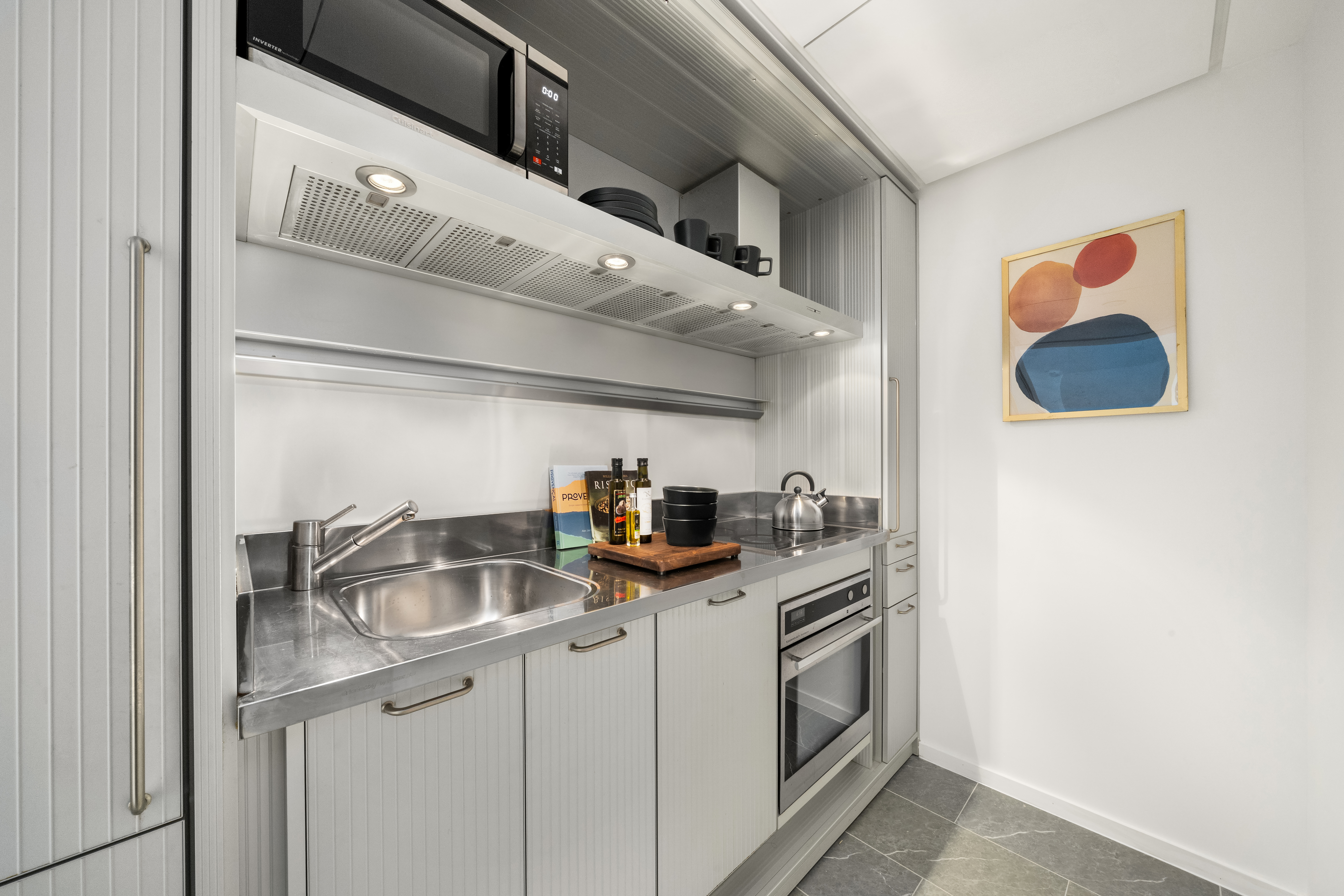 18 West 48th Street, Unit 4F Manhattan, NY 10036 - Photo 5 of 20 a kitchen that has a sink and a stove