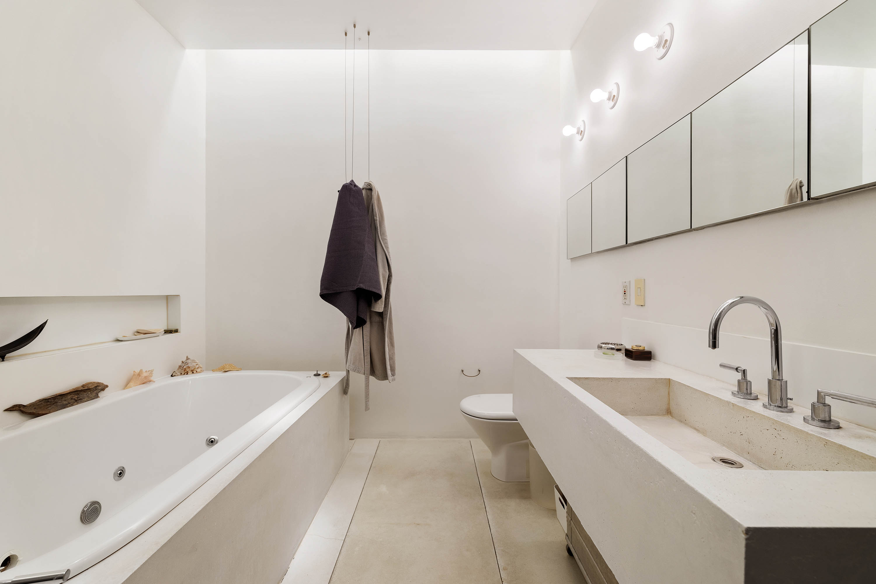 240 Centre Street, Unit 2B Manhattan, NY 10013 - Photo 7 of 12 a bathroom with a sink and a bathtub