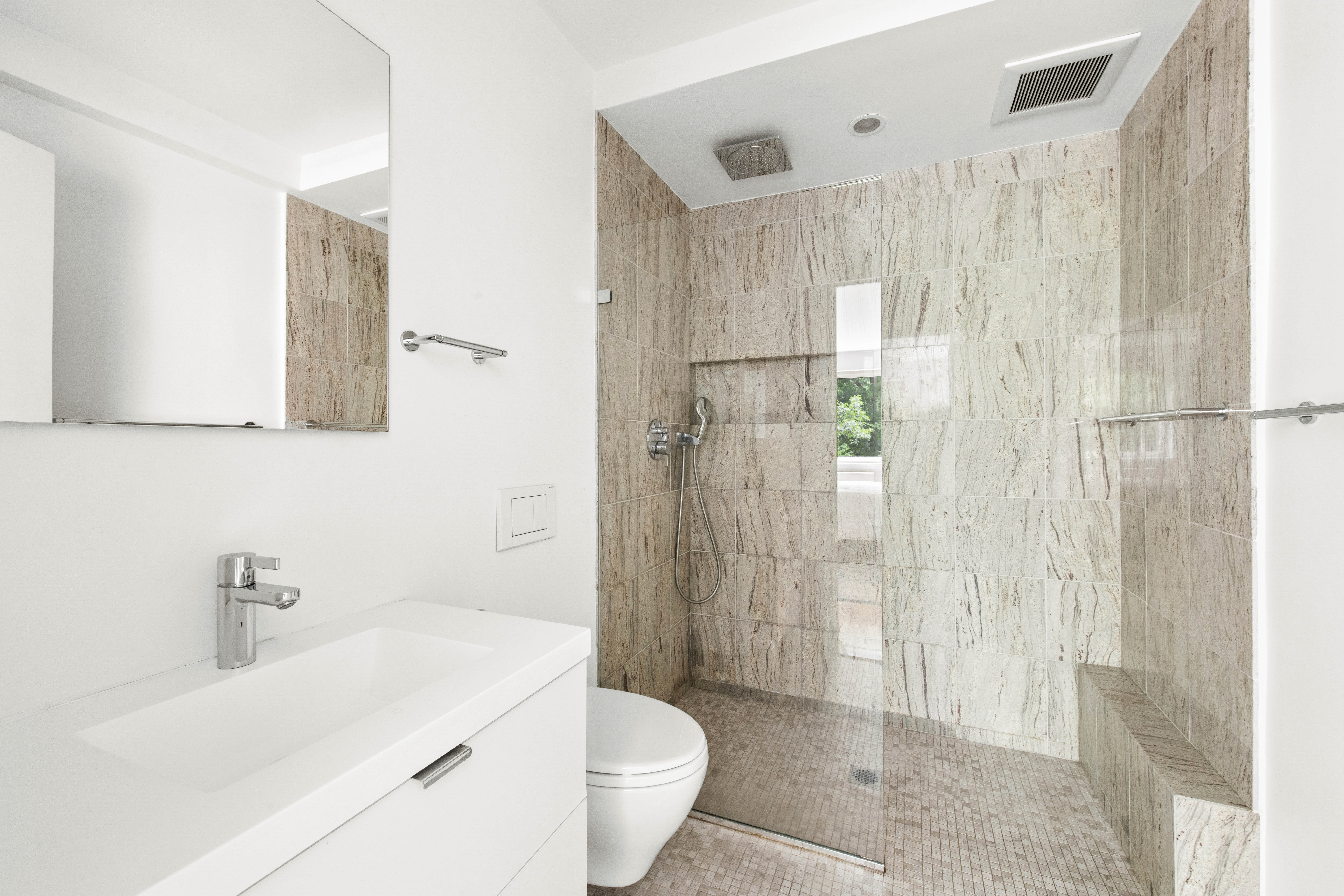 860 5th Avenue, Unit 3H Manhattan, NY 10065 - Photo 10 of 17 a bathroom with a sink a toilet and shower