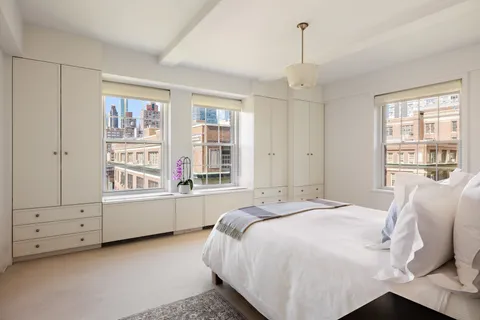 a bed room with a bed and a window