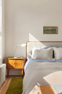 a bedroom with a bed and window