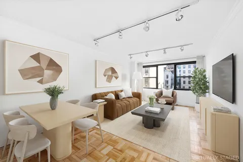 a living room with furniture large window and wooden floor