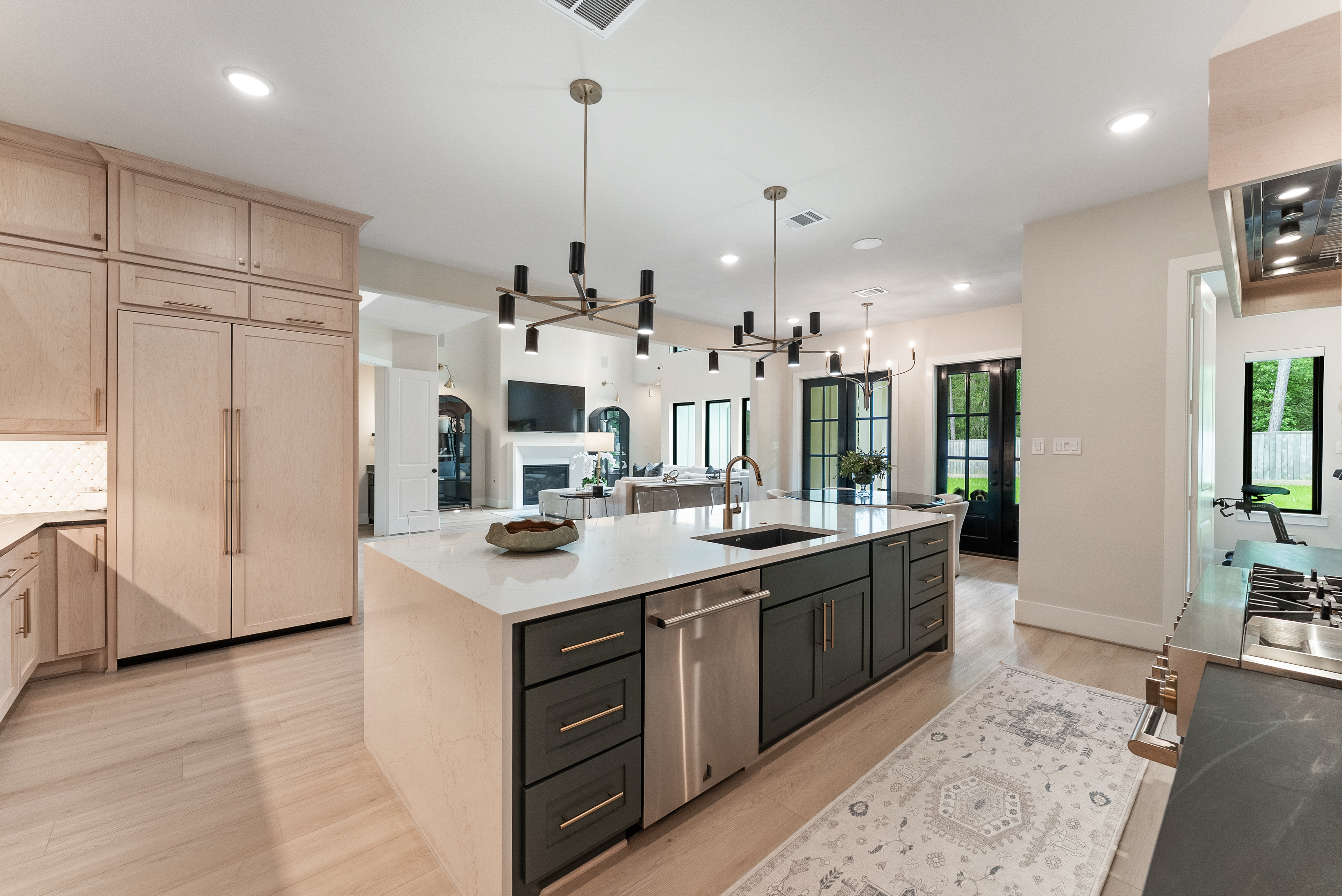 2118 Bennet Court Conroe, TX 77384 - Photo 19 of 70 a kitchen with stainless steel appliances kitchen island granite countertop a sink and a refrigerator