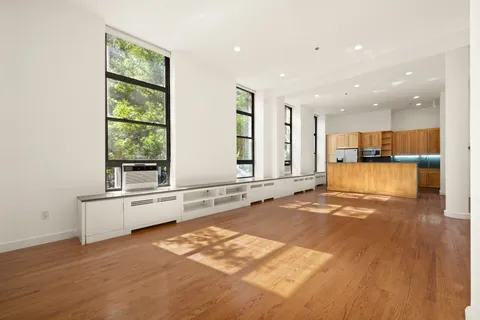 a bedroom with a bed and a large window