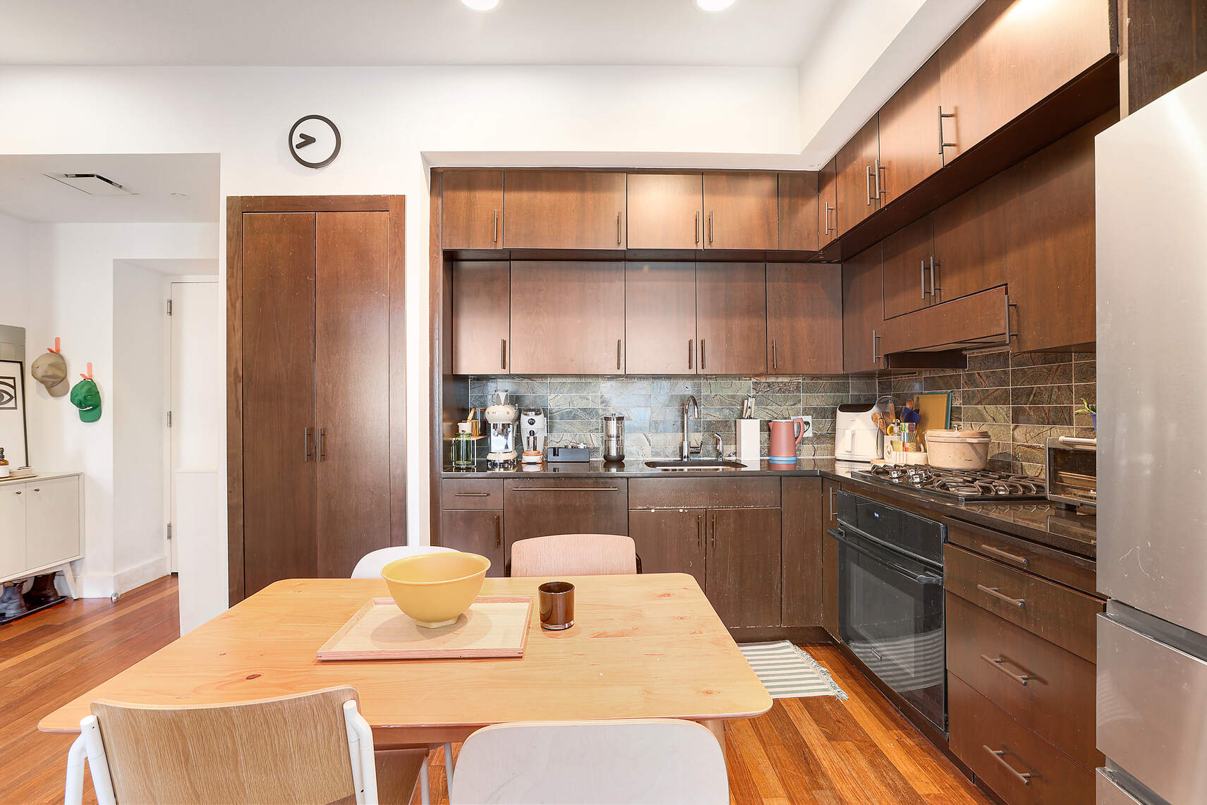 150 Myrtle Avenue, Unit 1105 Brooklyn, NY 11201 - Photo 2 of 24 a kitchen with a table chairs stove and refrigerator