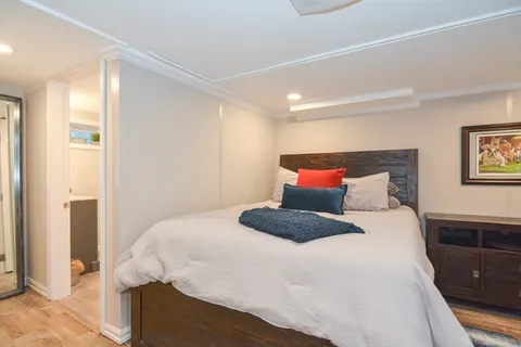 a bedroom with a bed and a night stand