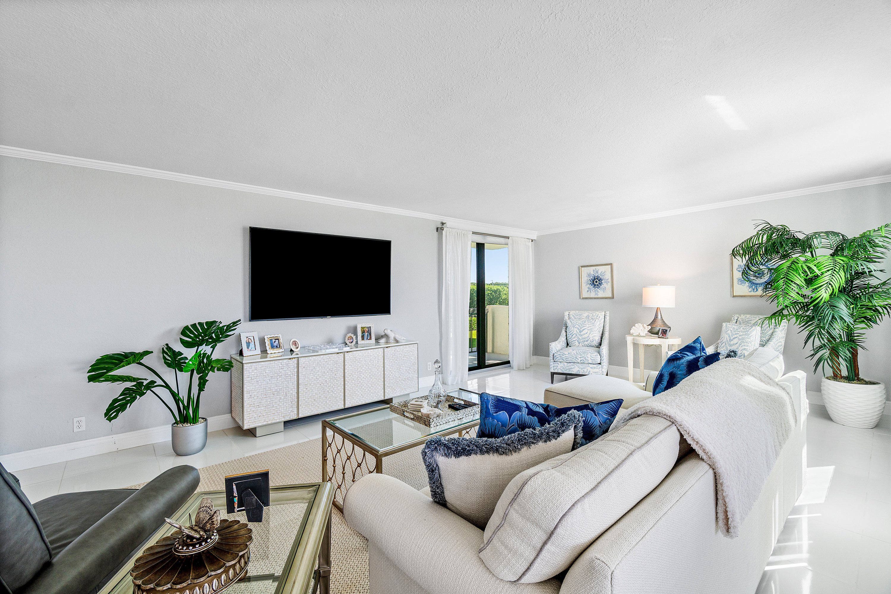 2003 North Ocean Boulevard, Unit 305 Boca Raton, FL 33431 - Photo 10 of 56 a living room with furniture and a flat screen tv