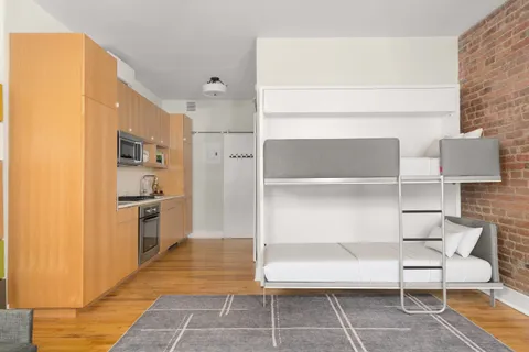 a kitchen with stainless steel appliances kitchen island granite countertop a refrigerator and a stove