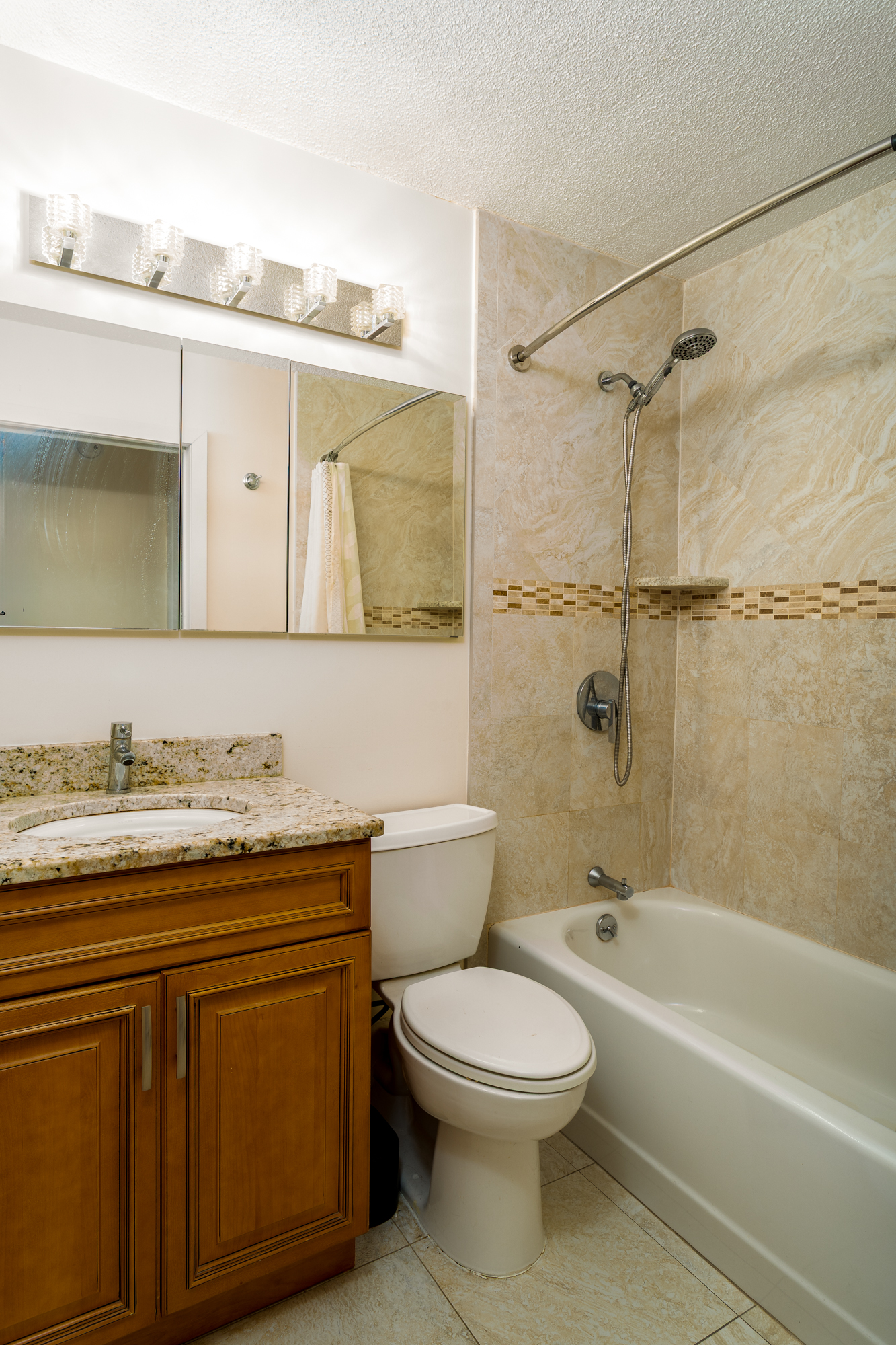 300 West 110th Street, Unit 16A Manhattan, NY 10025 - Photo 10 of 13 a bathroom with a granite countertop bathtub shower sink vanity and toilet