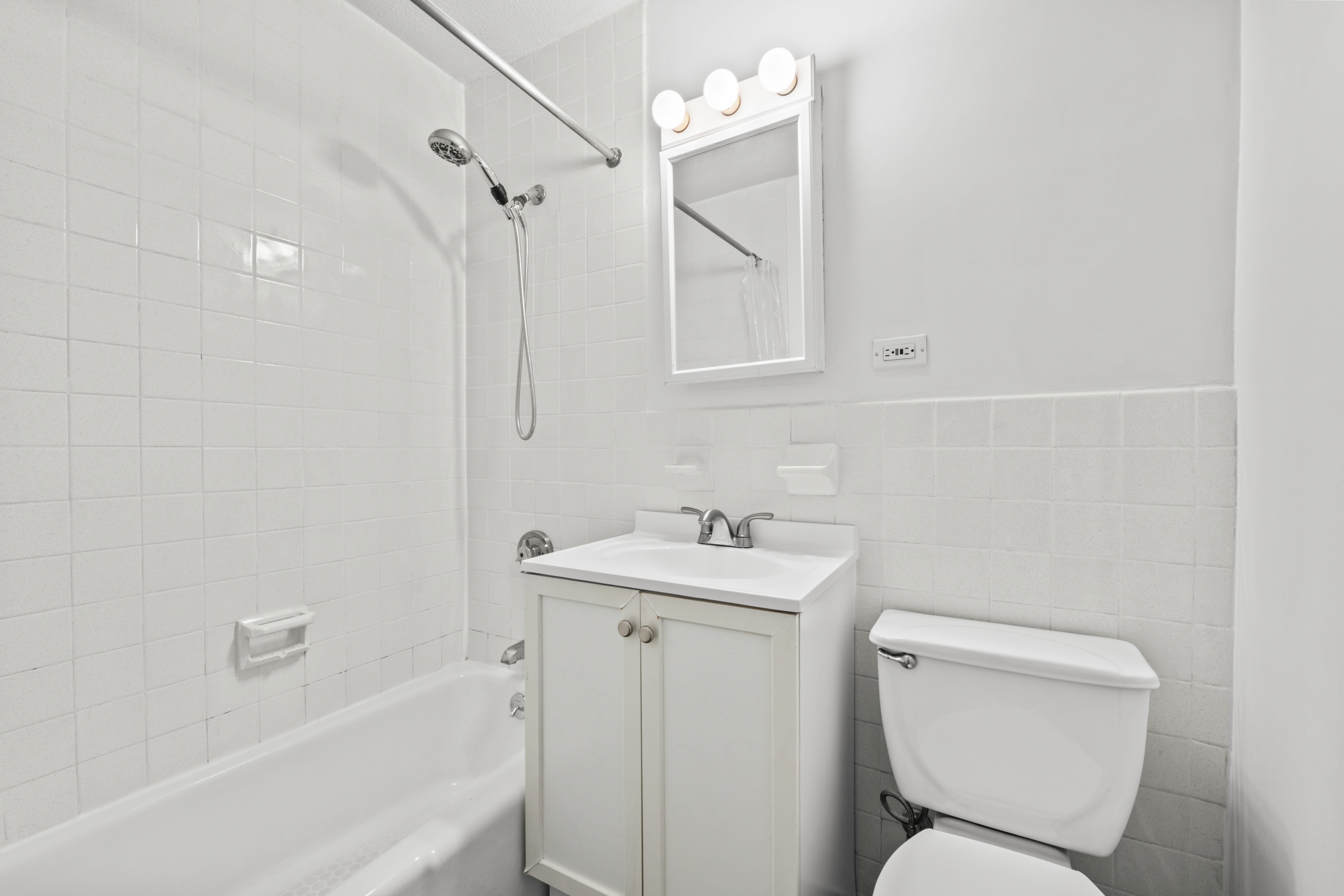 609 Columbus Avenue, Unit 14C Manhattan, NY 10024 - Photo 6 of 8 a bathroom with a toilet sink and mirror