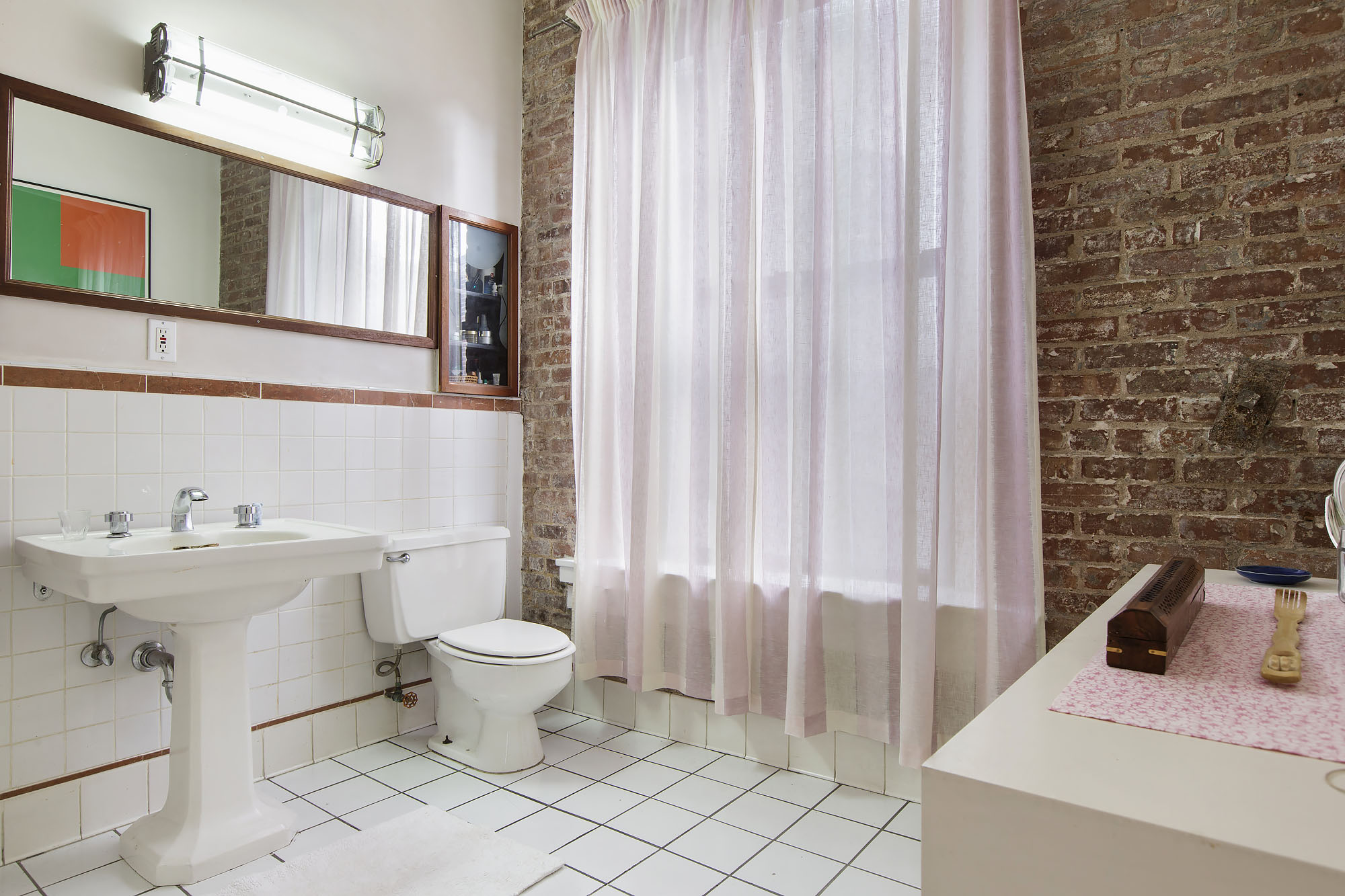 35 Bond Street Manhattan, NY 10012 - Photo 6 of 7 a bathroom with a sink toilet and shower