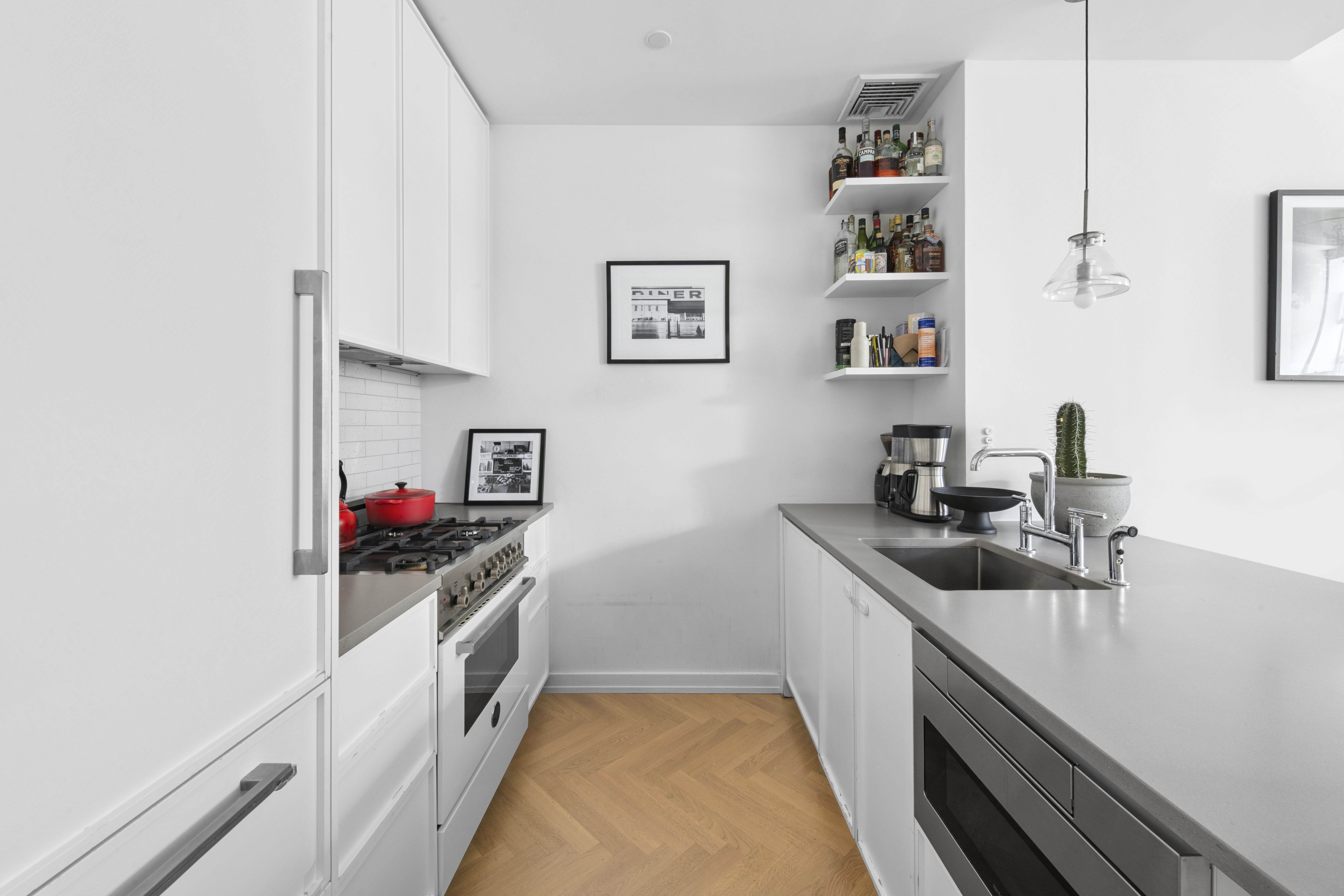 184 Kent Avenue, Unit D315 Brooklyn, NY 11249 - Photo 3 of 19 a kitchen with a sink and cabinets