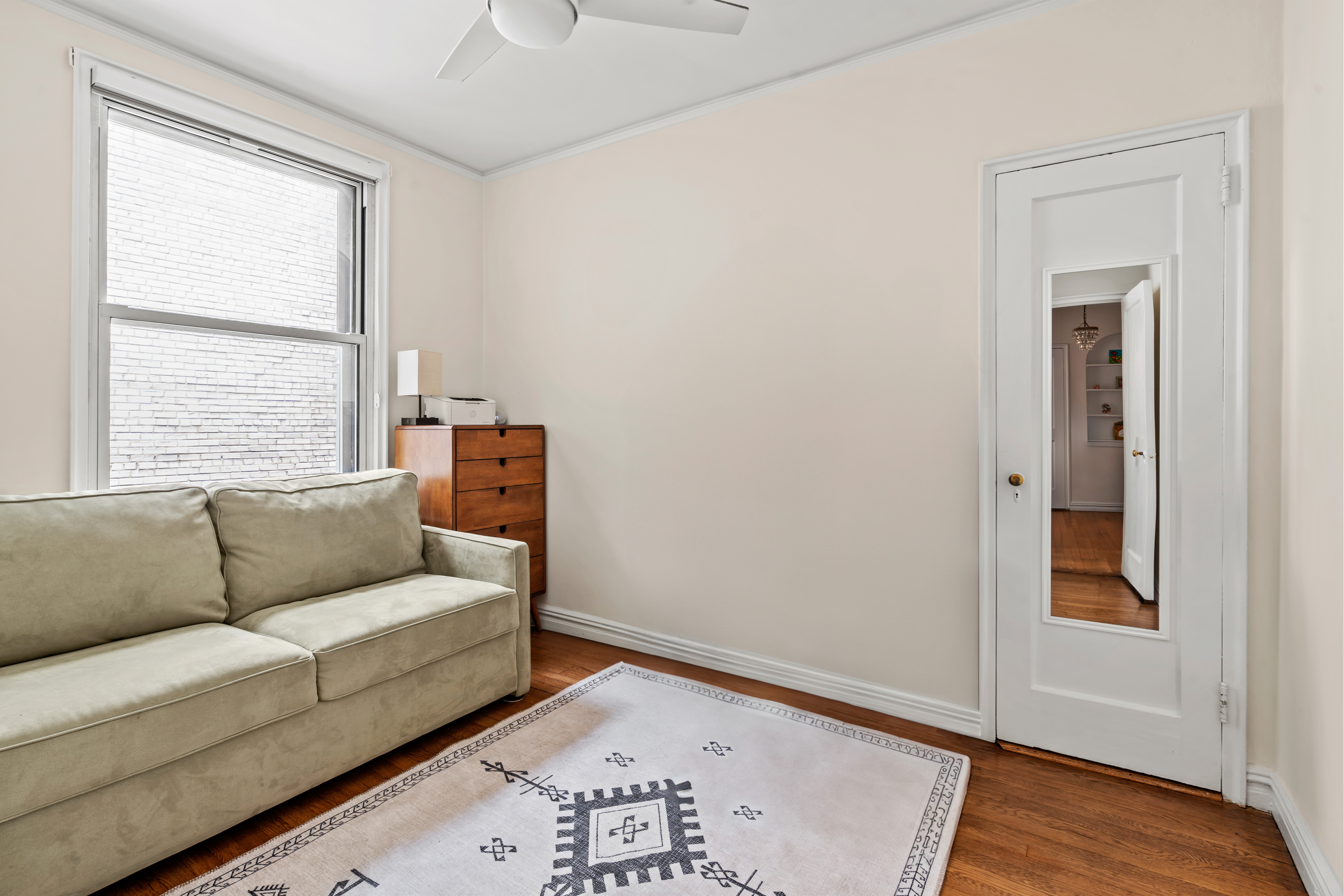 225 West 25th Street, Unit 5D Manhattan, NY 10001 - Photo 8 of 16 a living room with furniture and a window