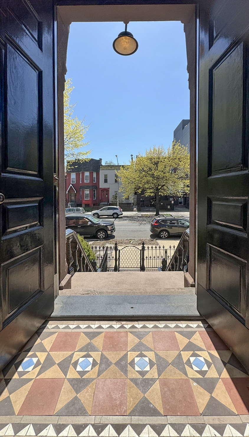 955 Bushwick Avenue Brooklyn, NY 11221 - Photo 15 of 19 a living room with a rug and a floor to ceiling window