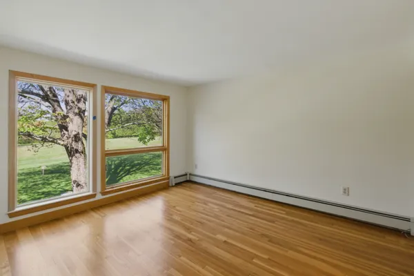 a view of room with window and wooden floor