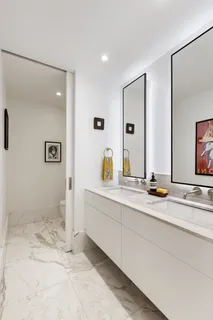 a spacious bathroom with a granite countertop sink and a mirror
