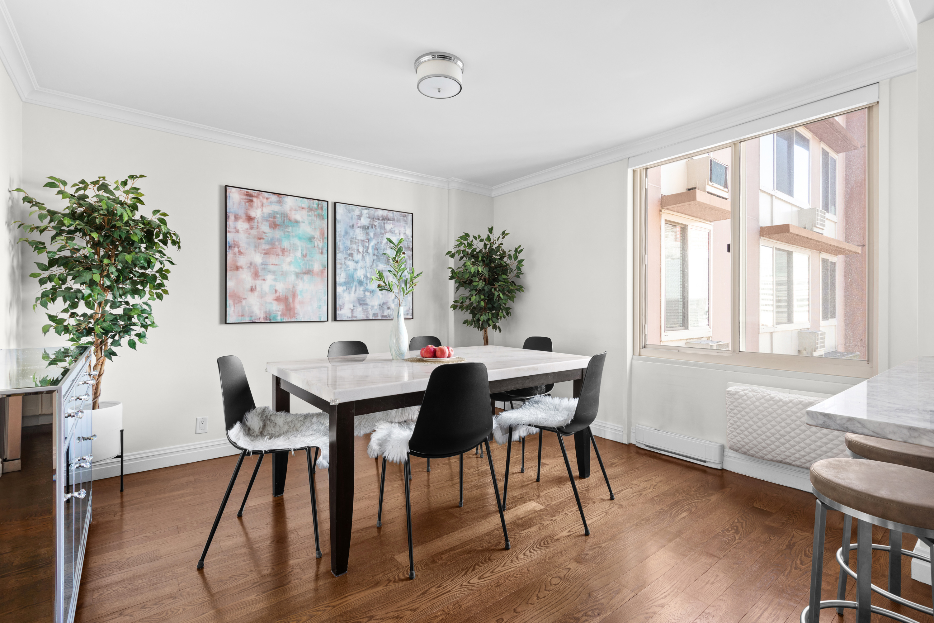 575 Main Street, Unit 509 Manhattan, NY 10044 - Photo 4 of 25 a view of a dining room with furniture window and wooden floor