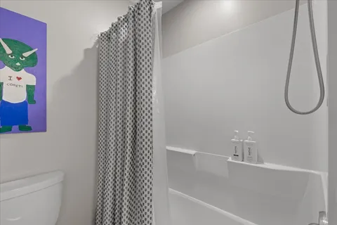a bathroom with a granite countertop sink a mirror a vanity and a shower