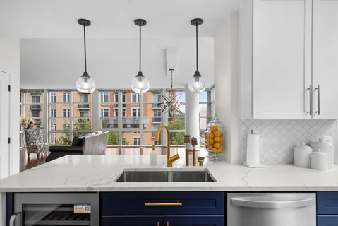 a bedroom with a bed chair and a large window