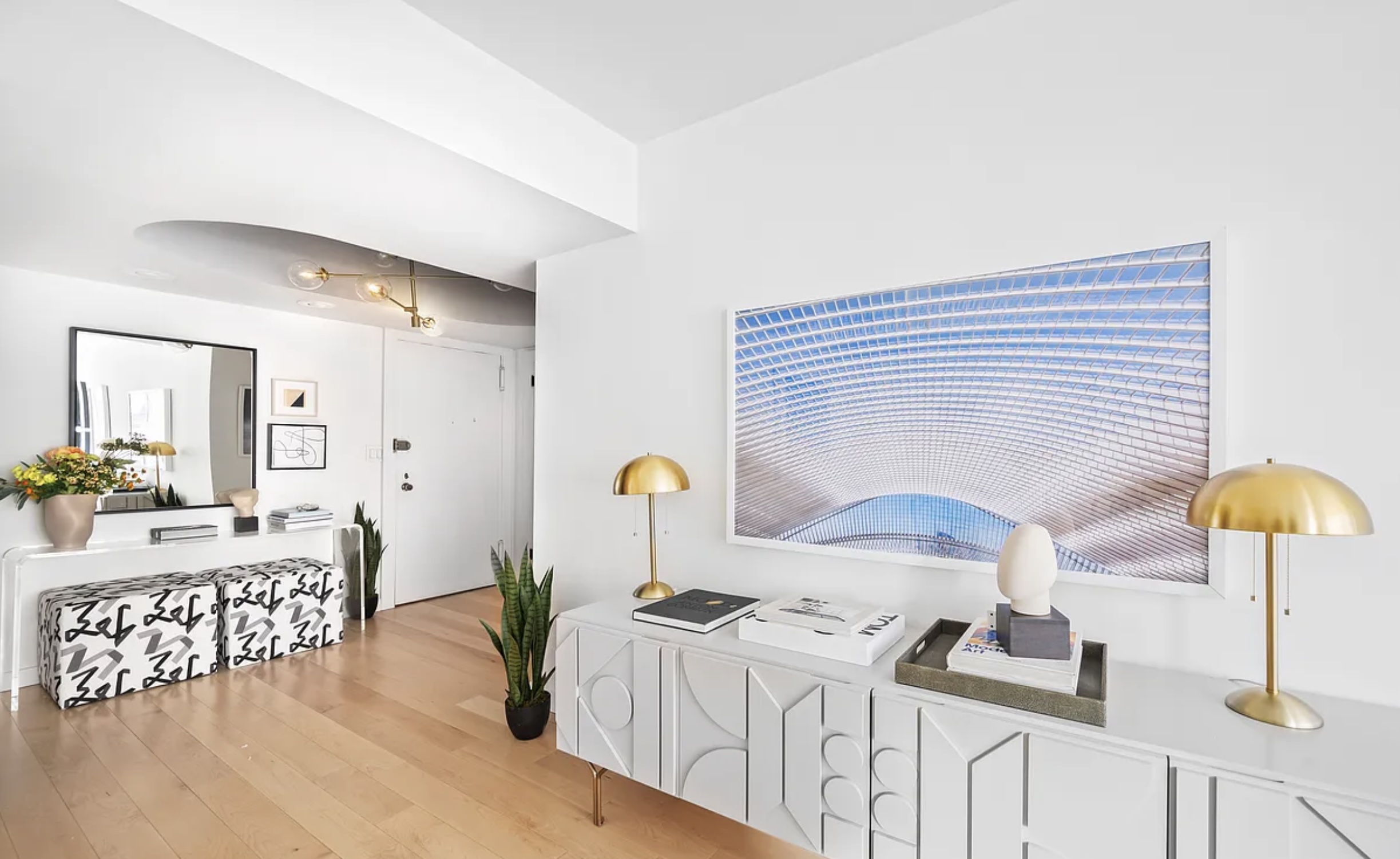 130 East 63rd Street, Unit 3D Manhattan, NY 10065 - Photo 3 of 13 a bedroom with furniture and a lamp