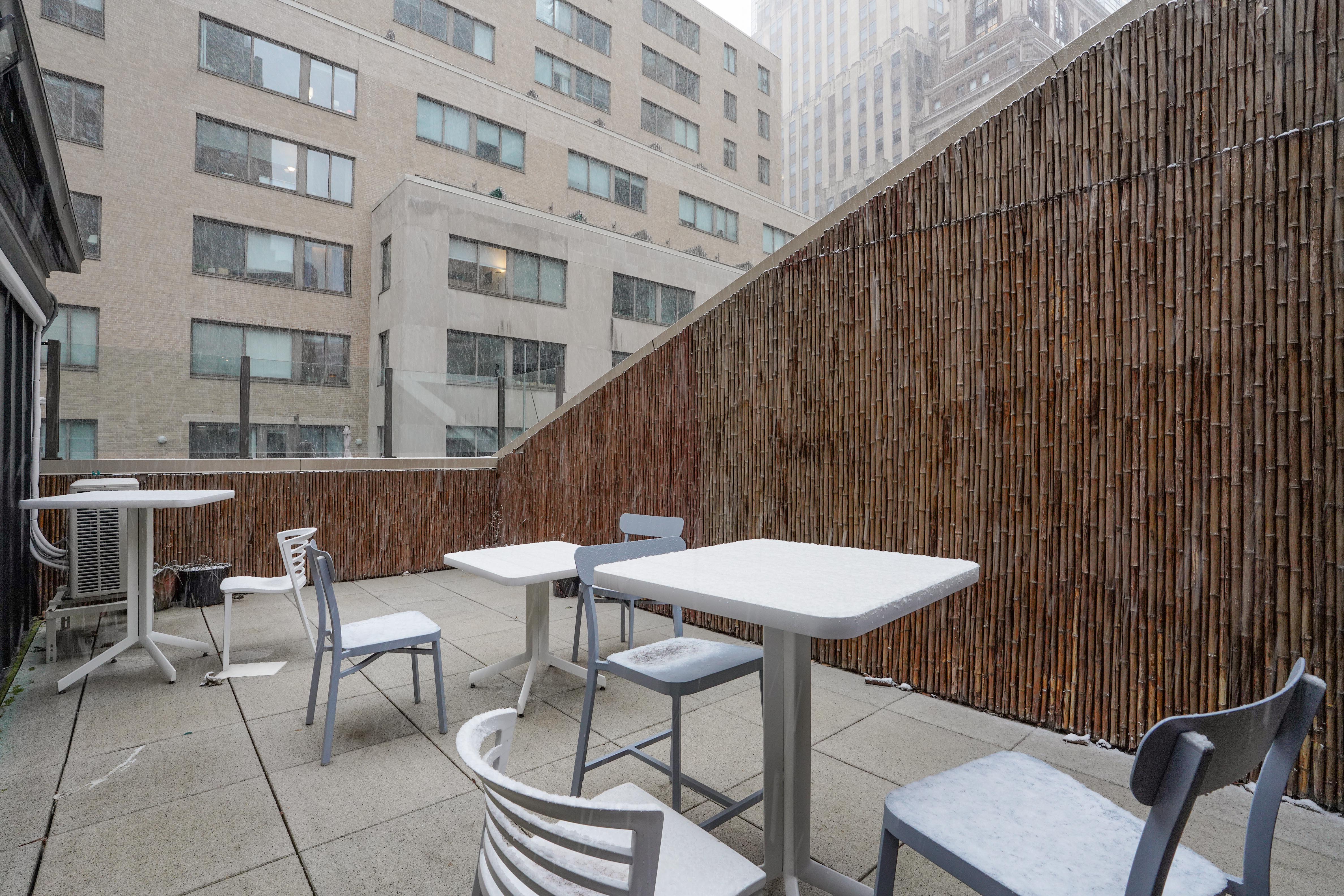 55 Wall Street, Unit PH910 Manhattan, NY 10005 - Photo 6 of 19 a balcony with table and chairs