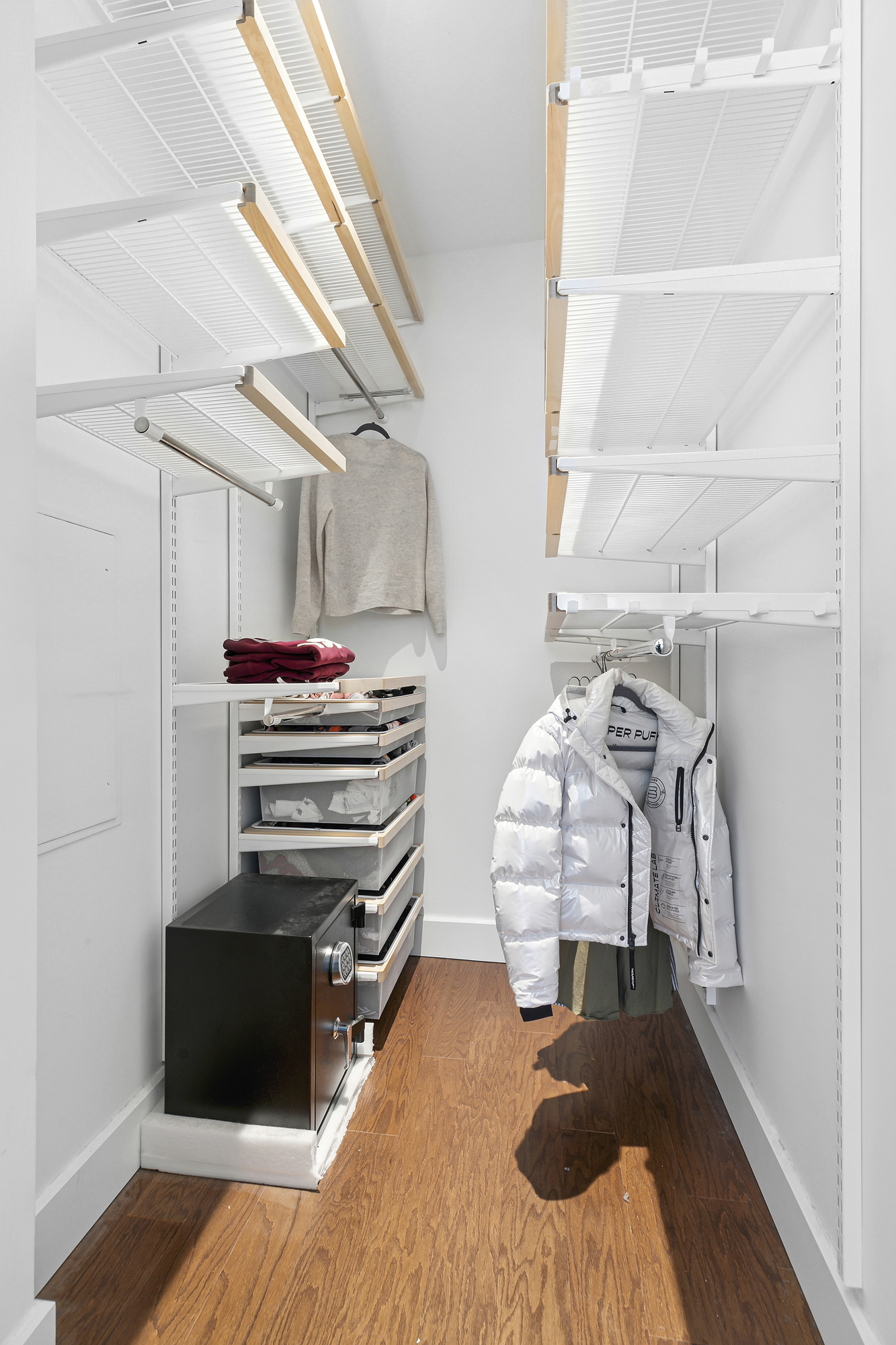 77 Bleecker Street, Unit 1212 Manhattan, NY 10012 - Photo 7 of 9 a bedroom with a bed and wooden floor