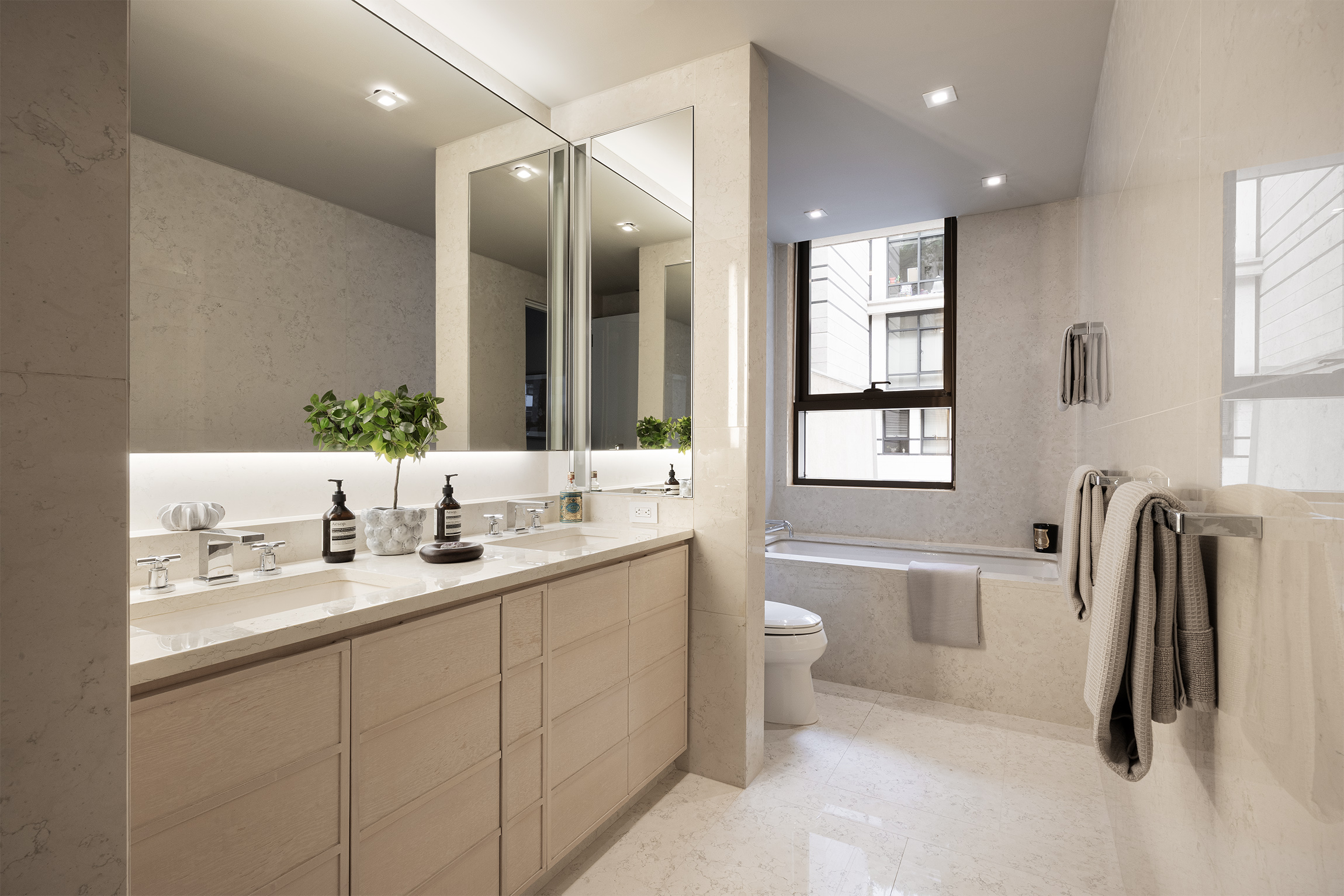 170 East End Avenue, Unit 2A Manhattan, NY 10128 - Photo 9 of 16 a bathroom with a double vanity sink a toilet and a mirror