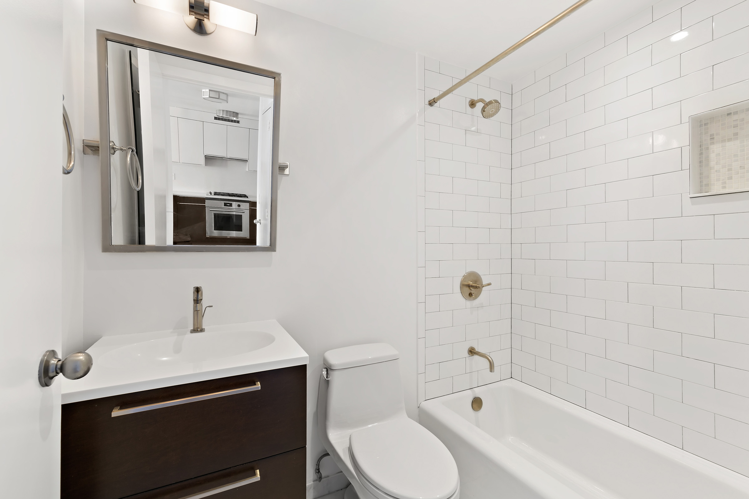 270 West 17th Street, Unit 11BC Manhattan, NY 10011 - Photo 7 of 13 a bathroom with a sink toilet a mirror and shower