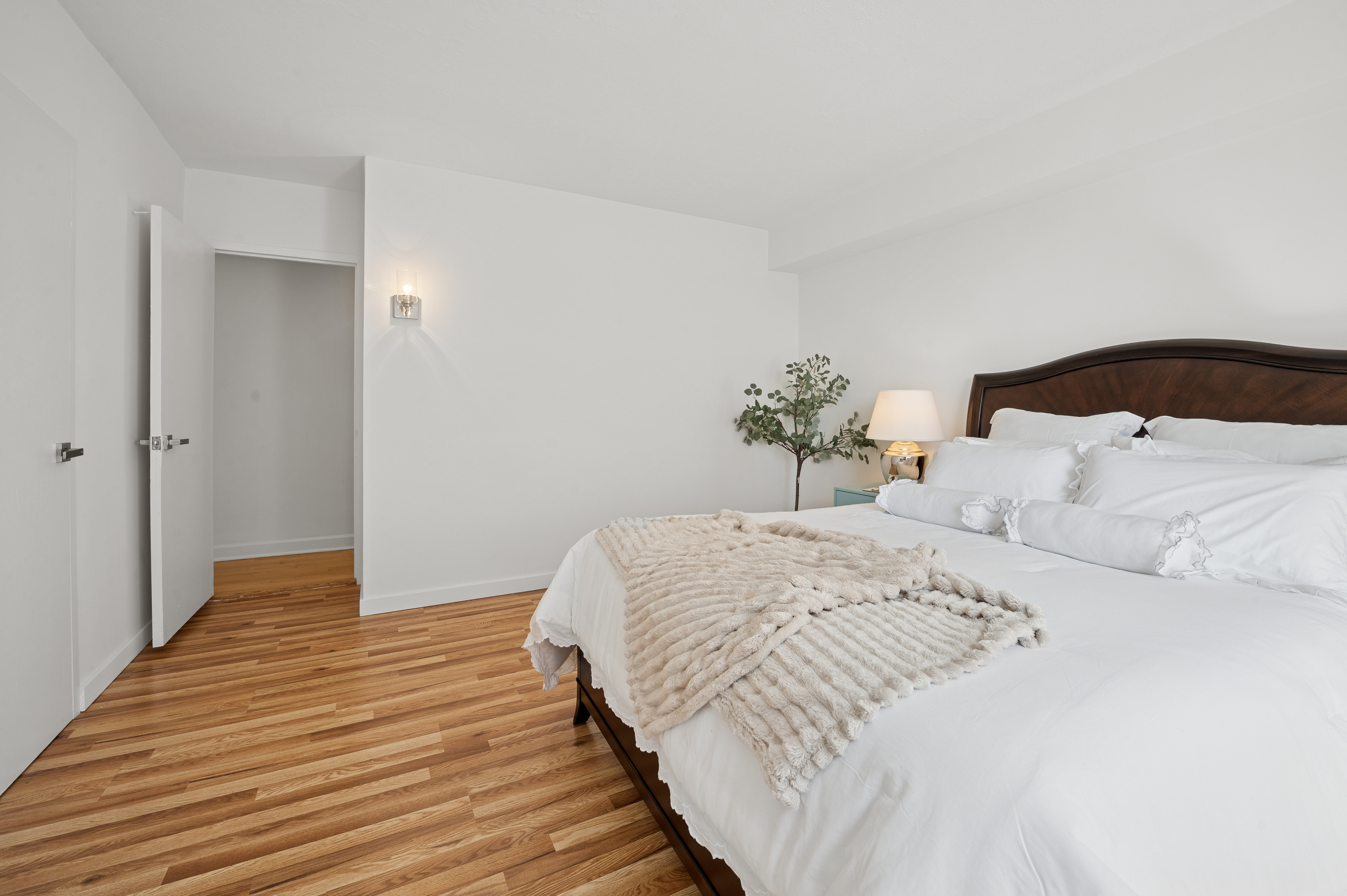 70 La Salle Street, Unit 8C Manhattan, NY 10027 - Photo 13 of 18 a bedroom with a bed and wooden floor