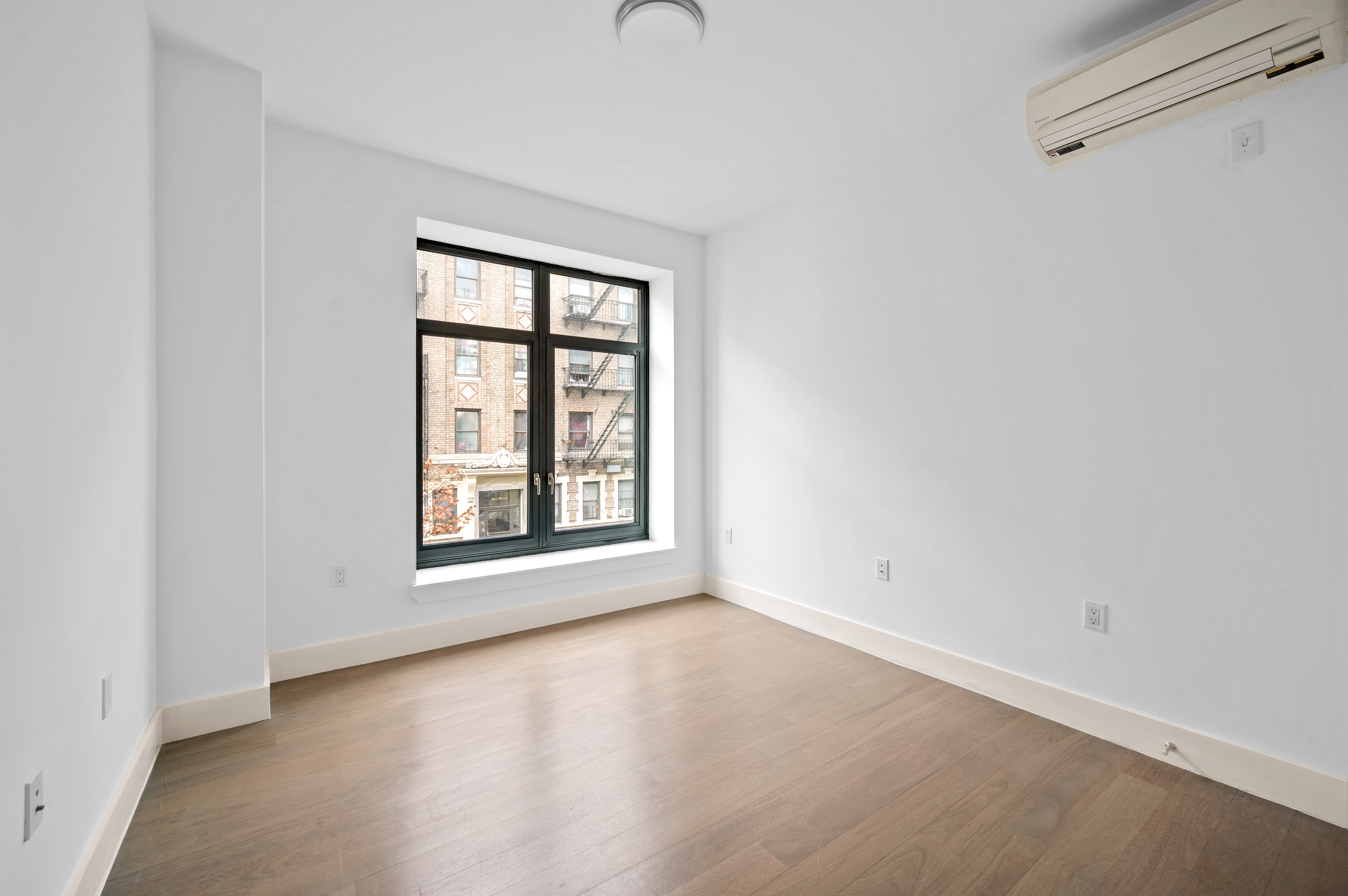 17 Convent Avenue Manhattan, NY 10027 - Photo 12 of 15 an empty room with a window