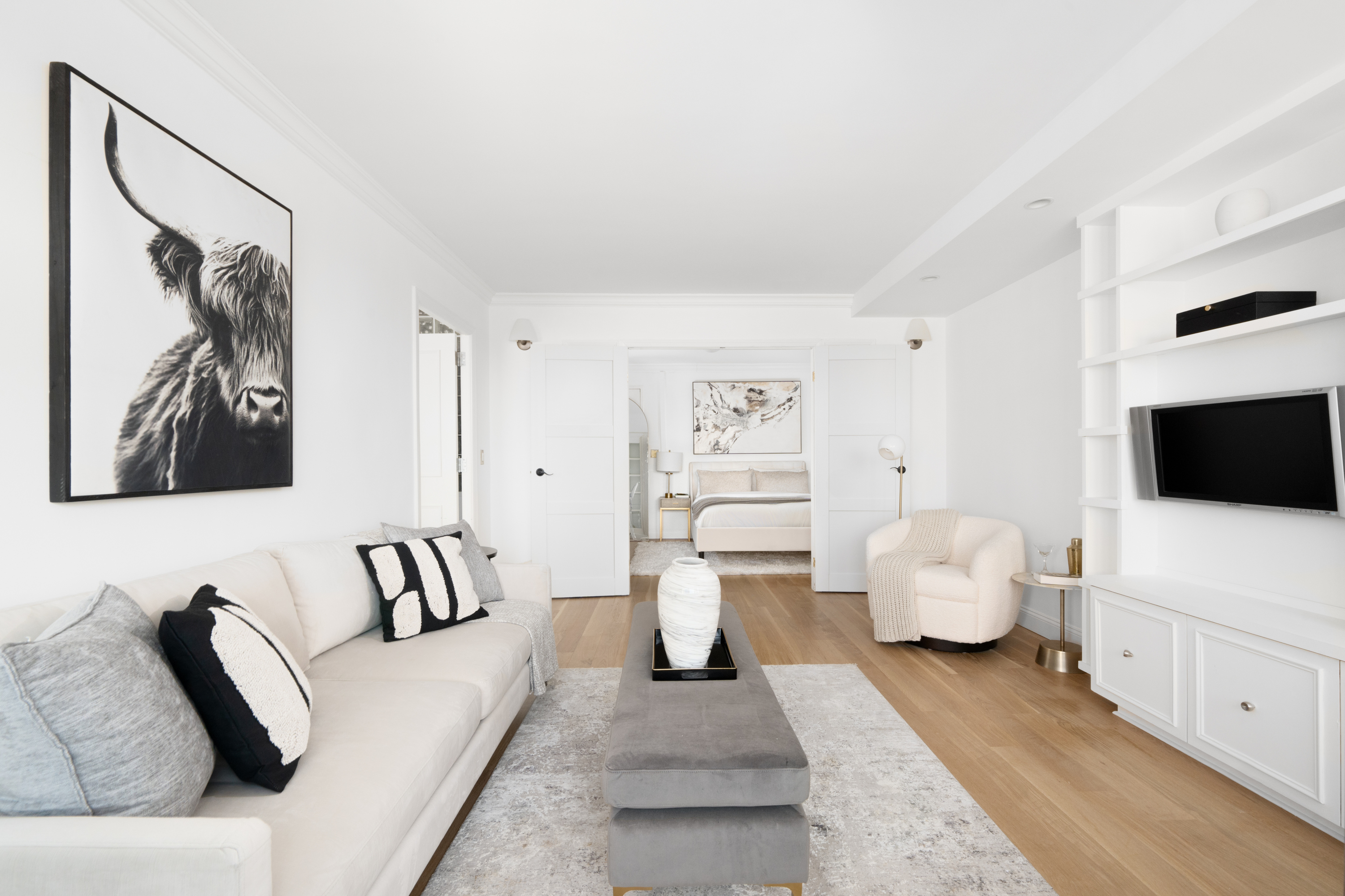 360 West 22nd Street, Unit 15C-14C Manhattan, NY 10011 - Photo 10 of 16 a living room with furniture and a flat screen tv