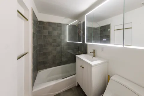 a bathroom with a sink toilet and shower