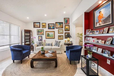 a living room with furniture and a book shelf